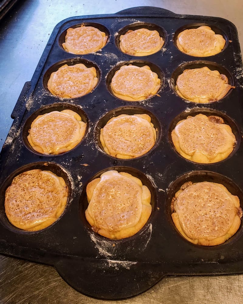 A dozen butter tarts fresh from the baking pan